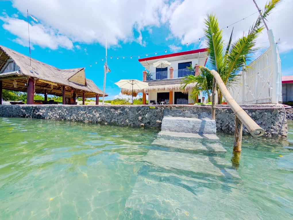 a house in the water with a water slide at On-the-beach JADE's BEACH VILLA 별장 Lapu-lapu Olango 별장 in Lapu Lapu City