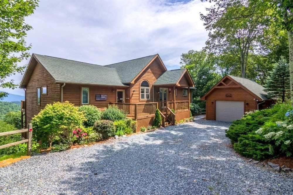 a log home with a garage and a fence at A Bears Eye View in Blowing Rock