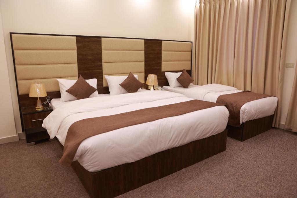 a hotel room with two beds in a room at Petra Brothers in Petra