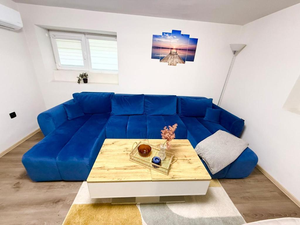 a blue couch in a living room with a table at ToP center of Varna in Varna City