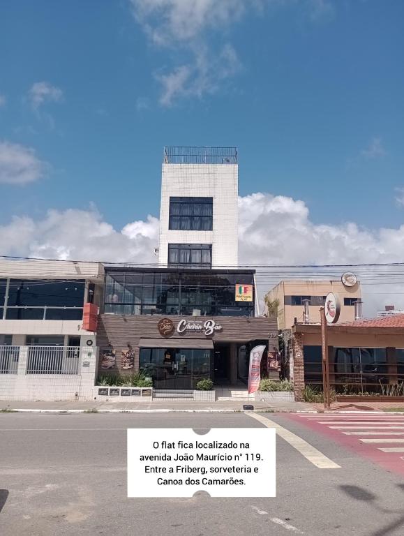 a building with a sign in front of it at Portugal Flat in João Pessoa