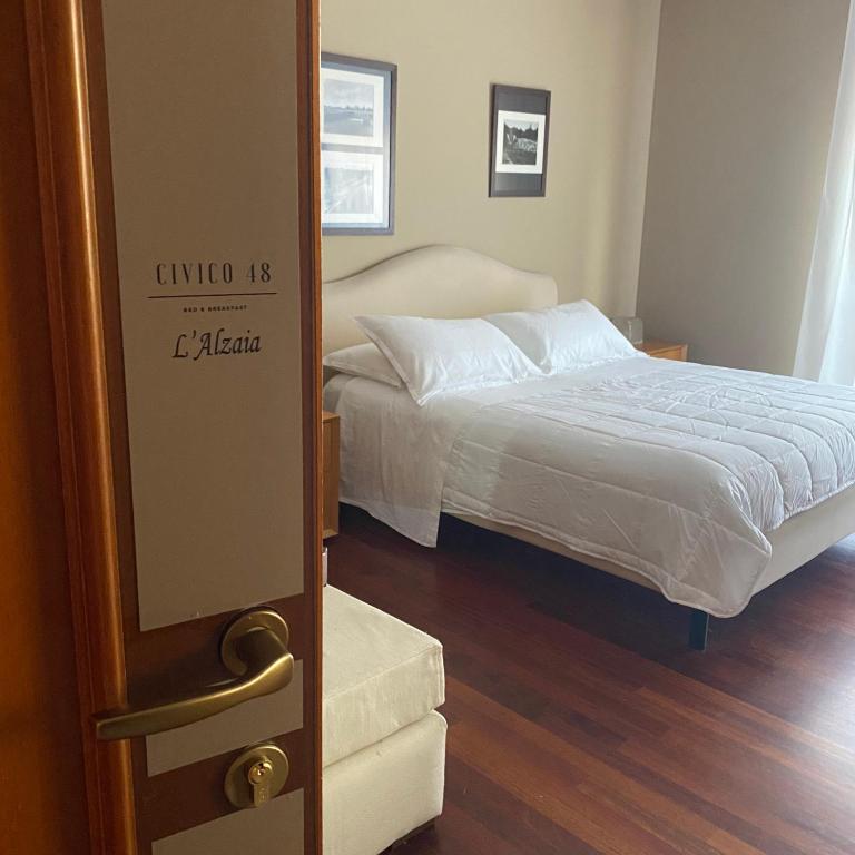 a bedroom with a bed and a door to a room at Civico 48 in Vizzola Ticino