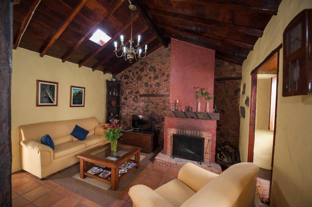 a living room with a couch and a fireplace at Casa Vidal in Guía de Isora