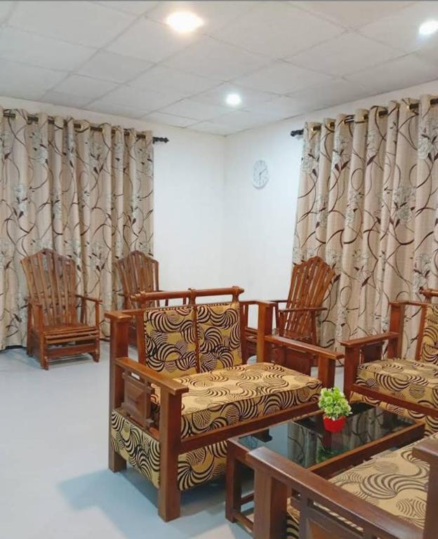 a room with chairs and curtains and a table at Dream Image in Midigama East