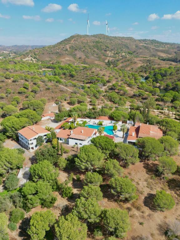 an aerial view of a house with two windmills at Quinta do Vale Entire Property in São Bartolomeu de Messines