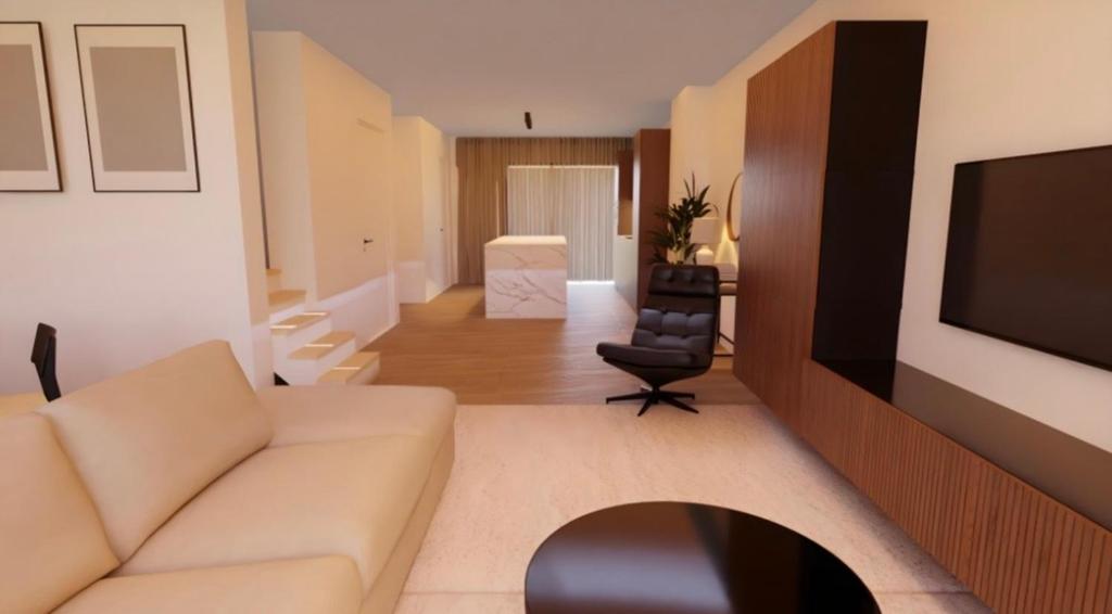 Una sala de estar con un sofá y un televisor. en Casa Blanc - Coastal Triplex, en Blankenberge
