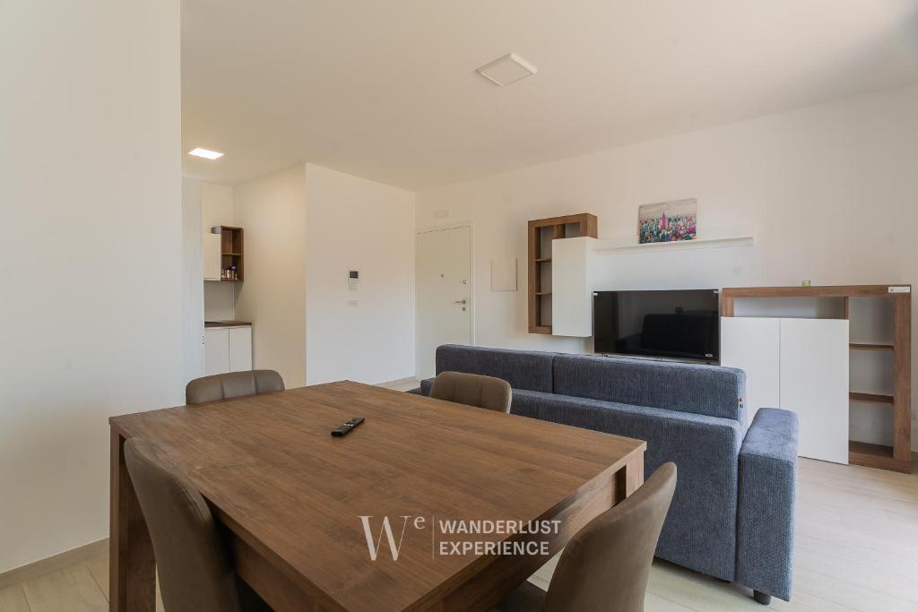 a living room with a blue couch and a table at Wanderlust Experience Vasari in Bitonto