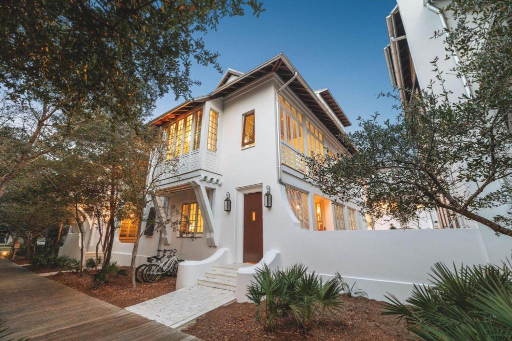 a white house with a white wall at Sadie's Cottage in Rosemary Beach