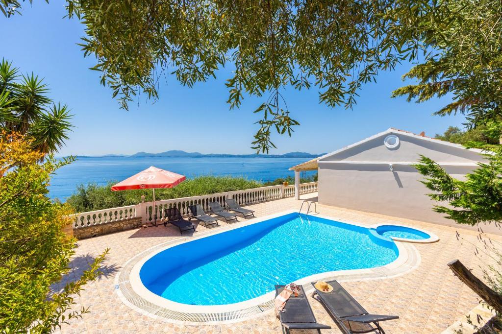 a pool with a view of the water at Villa Theodora in Nisakion