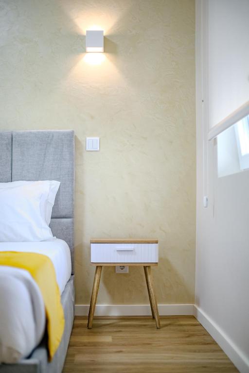 a bedroom with a bed with a nightstand next to it at Black Sand Cozy Apartment in Livramento