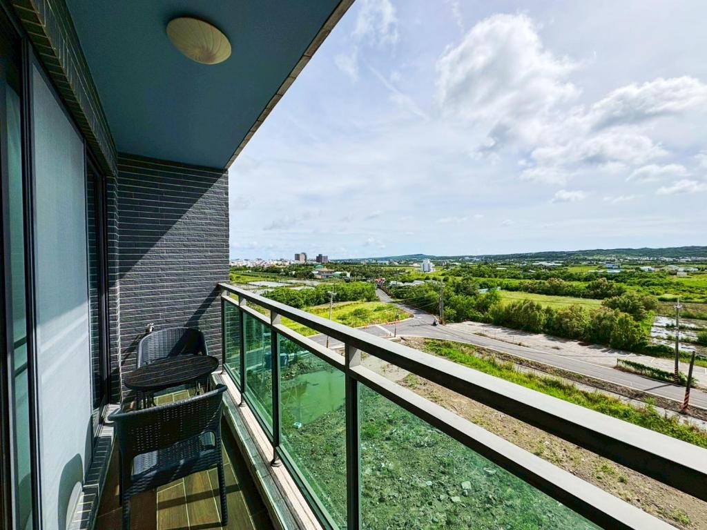 a balcony with a view of a city at 恆春夏居心澍包棟民宿 10至20人入住 烤肉電動麻將水池Ktv in Hengchun