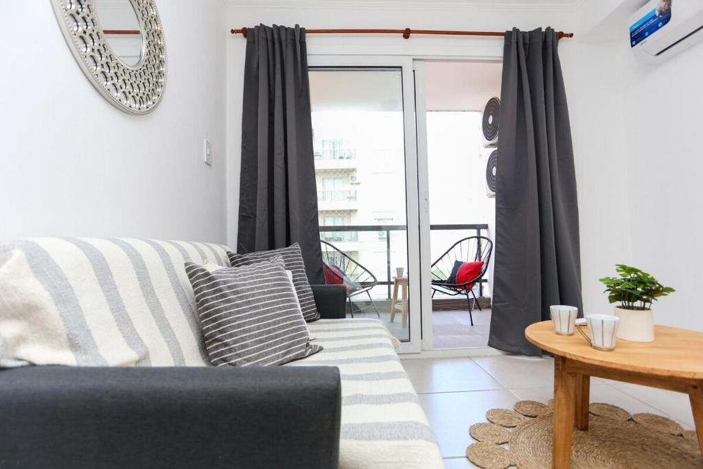 a living room with a couch and a table at Departamento a estrenar centro-sur Santa Fe - Urquiza II in Santa Fe