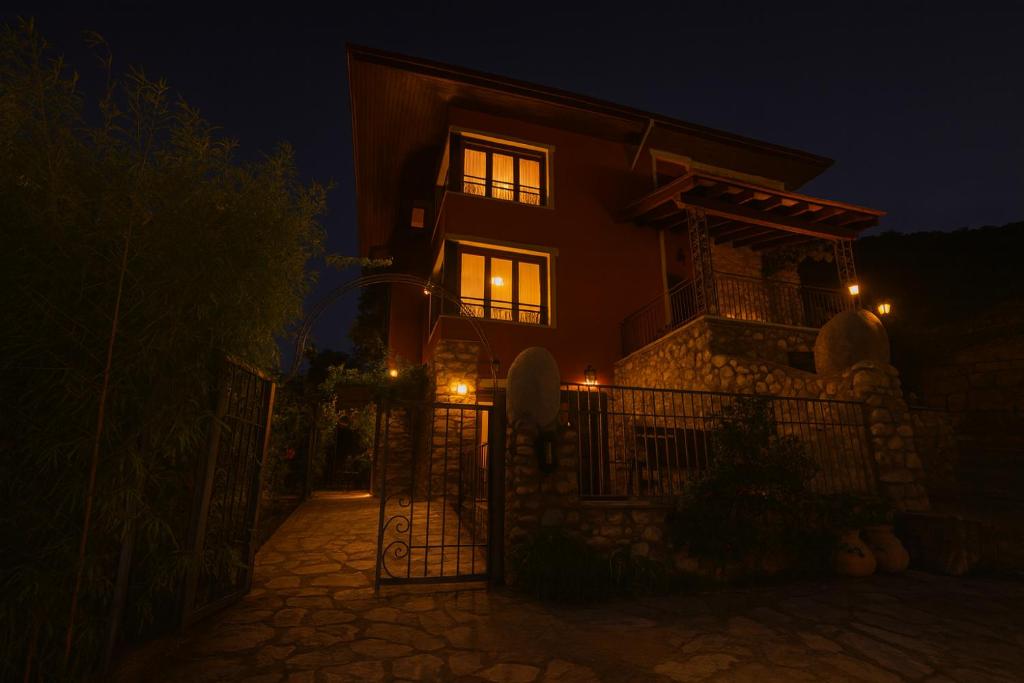 a house with a gate at night with lights at Masia Boutique con Infinity Pool in Calvinyá