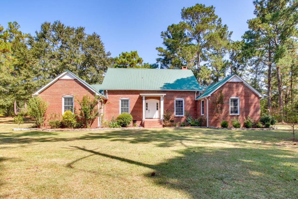 una casa de ladrillo rojo con techo verde en Screened Porch Peaceful Country Escape in Ashford, en Dothan