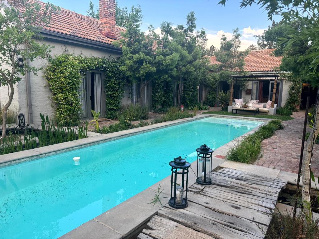 a swimming pool in front of a house at Veranda House Boutique Accommodation in Midrand
