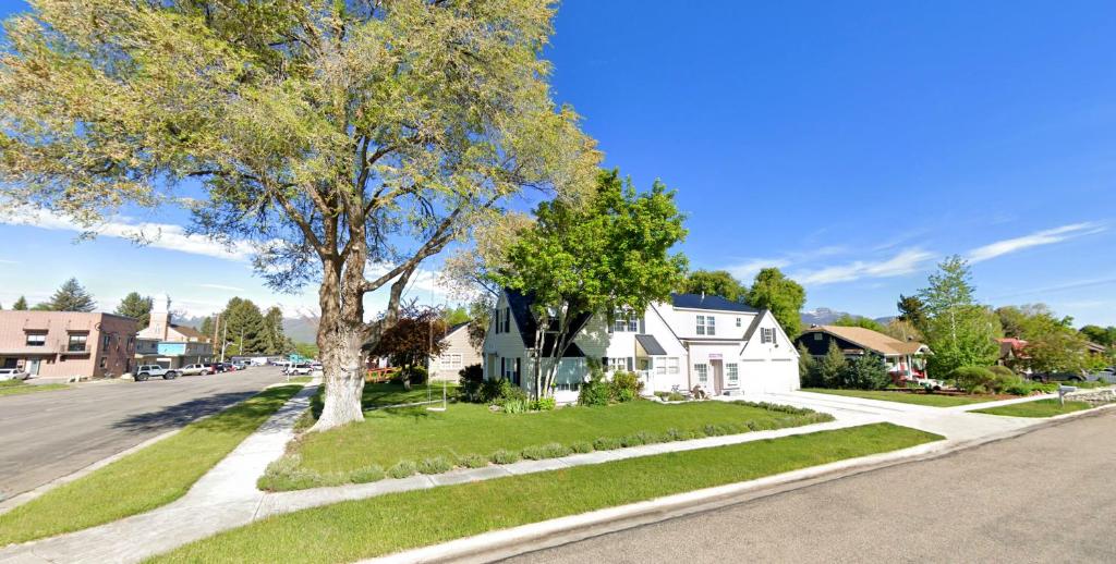 a tree on the side of a street with a house at 2 Heber homes lg groups 7br 5ba hot tub decks in Heber City