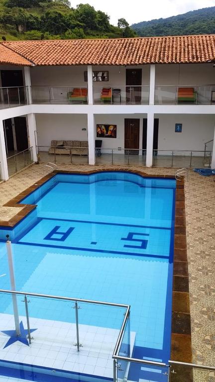 a large swimming pool in front of a building at Hotel monas in San Gil