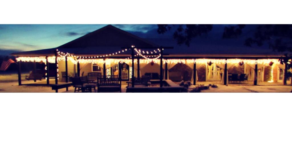 a marquee lit up at night with christmas lights at Deer Creek Winery at Brooks Estate in Shippenville