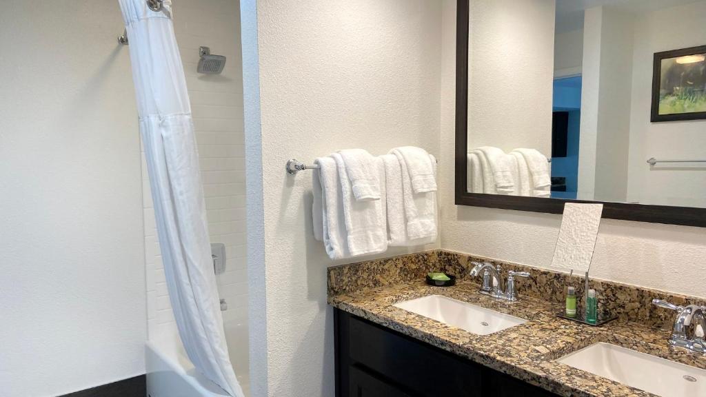 a bathroom with two sinks and a mirror at Club Wyndham Branson at The Falls in Branson