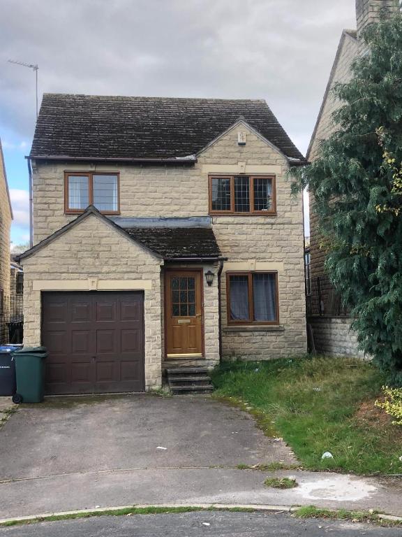 a brick house with a garage in a driveway at Very Quite and Comfortable Place in Clayton