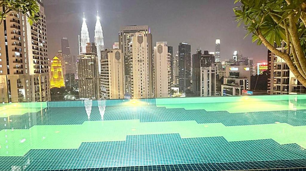 a swimming pool with a view of a city at Majestic Residence Suites KLCC in Kuala Lumpur