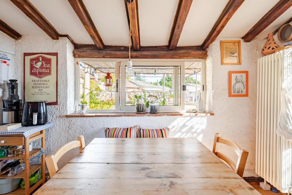a dining room with a wooden table and chairs at The Terrace of San Pellegrino - Historic Center in Viterbo