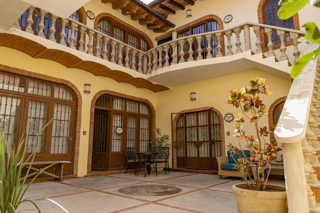 an internal courtyard of a house with a staircase at Suite Amapas in the heart of Romantic Zone in Cedro