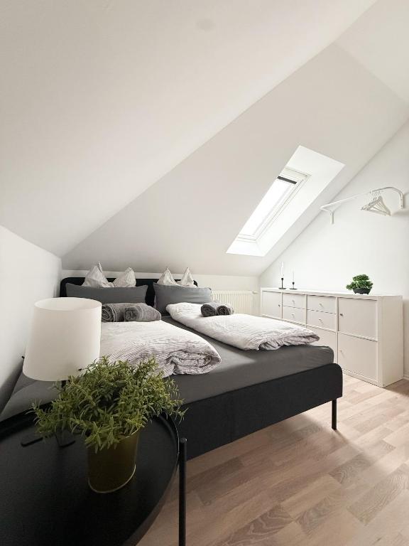 a bedroom with a large bed with a white ceiling at Wattwürmchen in Wremen