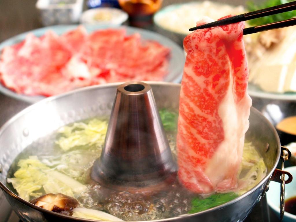 a pot of food with meat in it at Hotel Symphony - Vacation STAY 67001v in Sagae