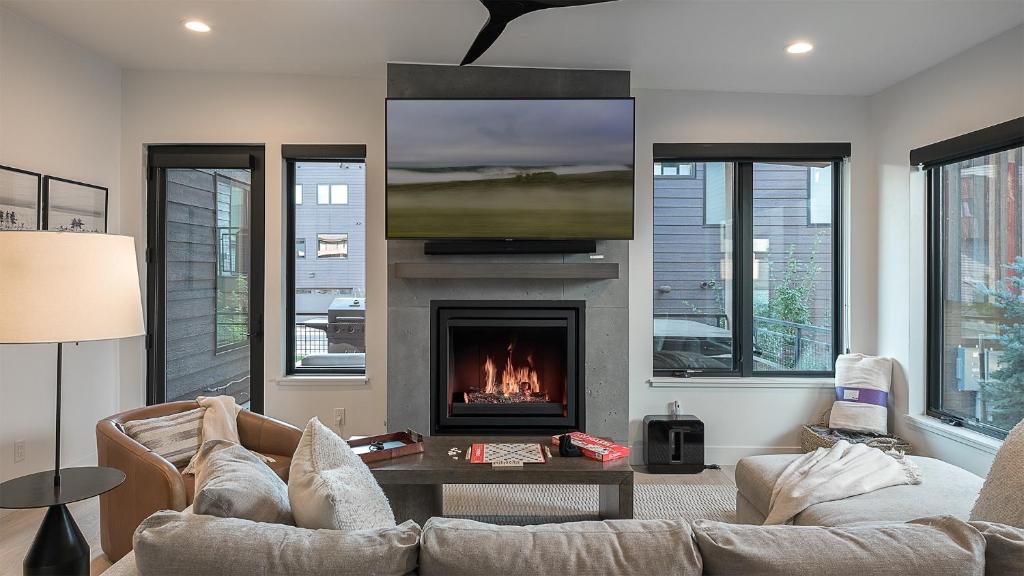 a living room with a couch and a fireplace at Principal House in Steamboat Springs