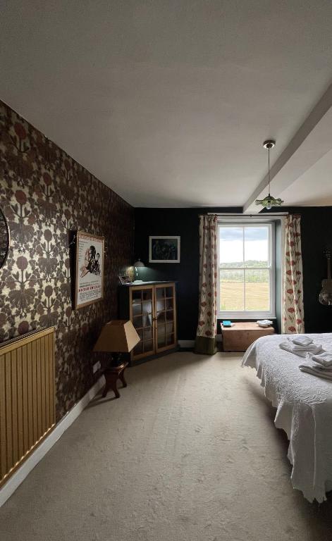 a bedroom with a large bed and a window at Three private rooms in the Master Suite, Cotswolds Coaching Inn - Traveller Awards Winner 2026 in Naunton