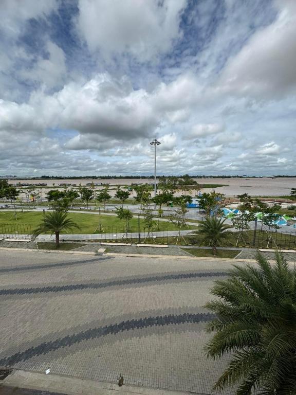 a parking lot with a street and a body of water at Two-bedroom flat - River view, elevator, free inside car parking in Mỹ Phước
