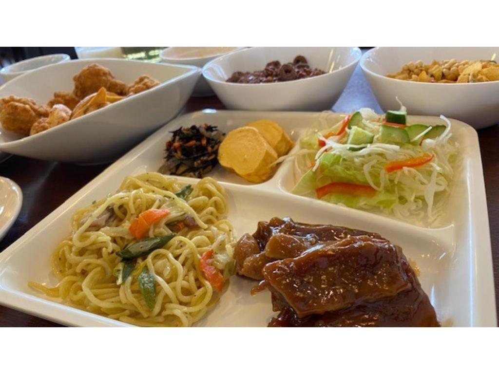 a plate of food with pasta and meat and other foods at Smile Hotel Tokyo Ayase Ekimae - Vacation STAY 62867v in Tokyo