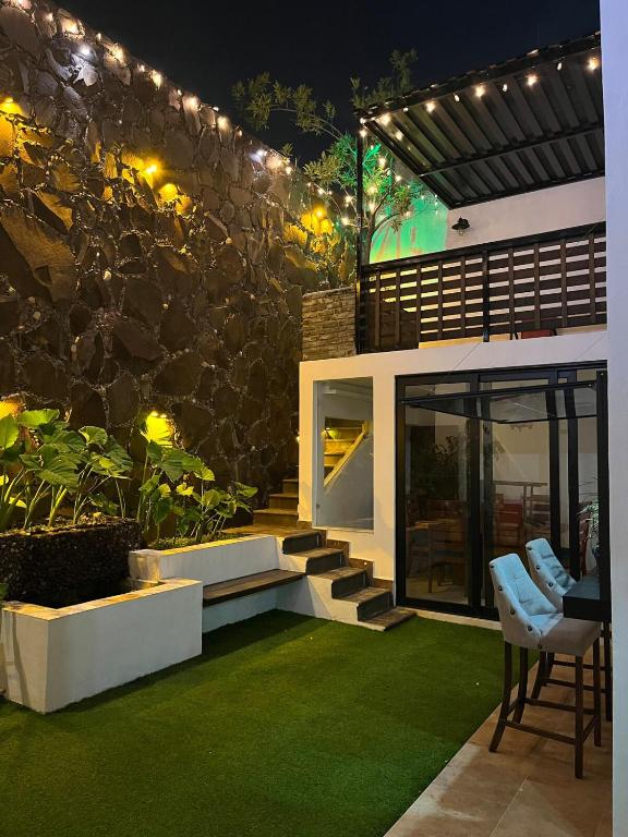 a house with a patio with green grass at BIG HOUSE, máximo 22 personas !!!!!!!!!!!!!!! in Guadalajara