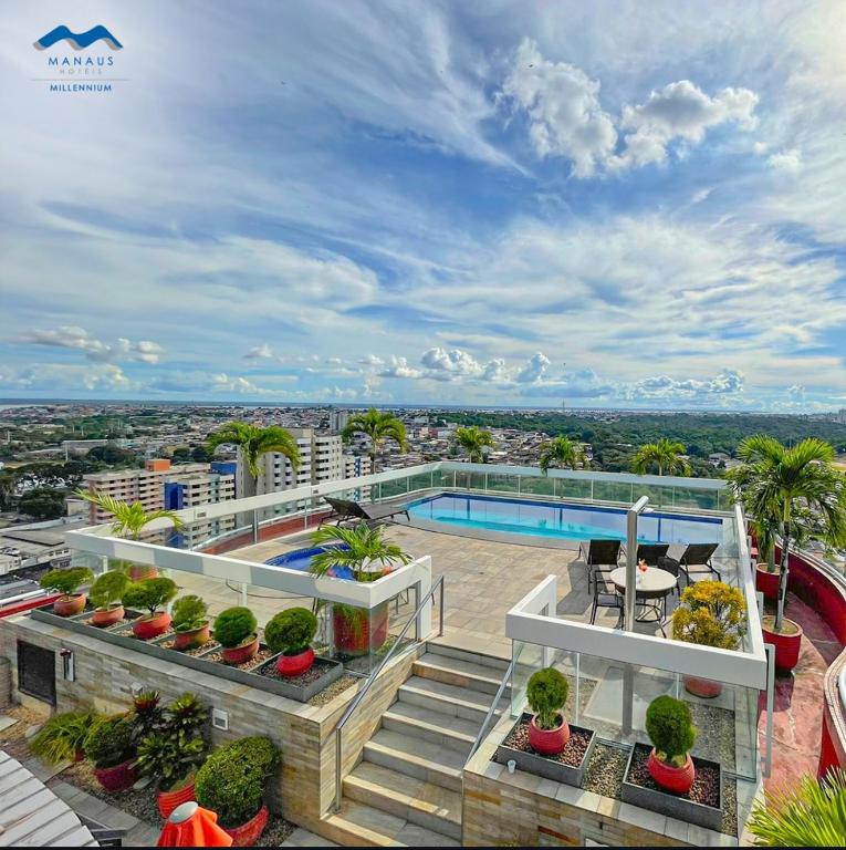 an apartment with a balcony with a swimming pool at Flat Aconchegante no Millenium Hotel in Manaus