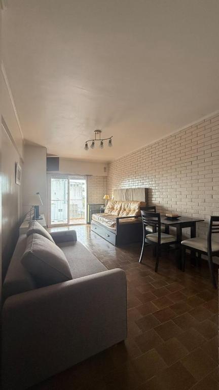 a living room with a couch and a table at MONOAMBIENTE muy cómodo a metros del mar in Mar del Plata