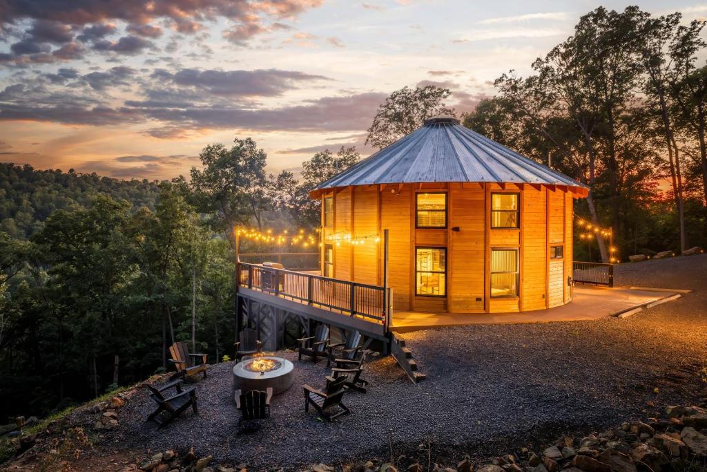 a cabin in the woods with a table in front of it at Skyline Yurt: Hot Tub~Wood Stove~WiFi~EVcharger in Front Royal