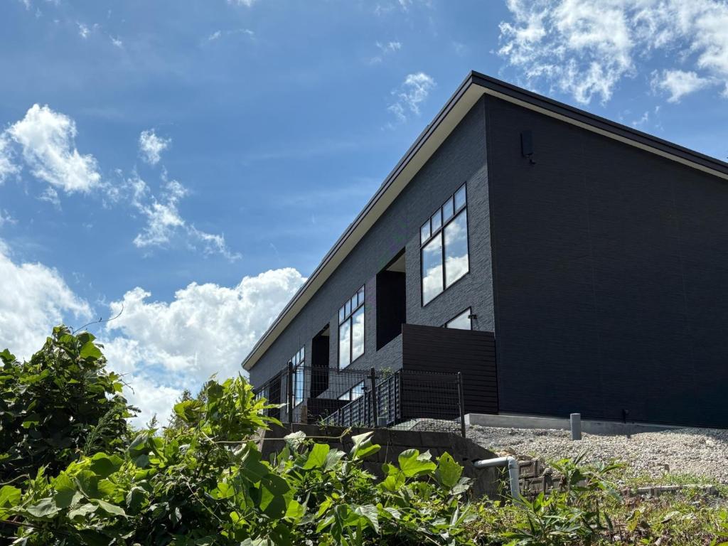 a black building with windows on the side of it at Tabinoteitaku BREATHTAKEMatsushima - Vacation STAY 66188v in Takagi