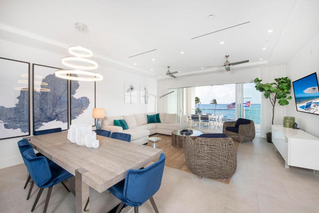 ein Esszimmer und ein Wohnzimmer mit einem Tisch und blauen Stühlen in der Unterkunft Rum Point Resort 206 in Driftwood Village