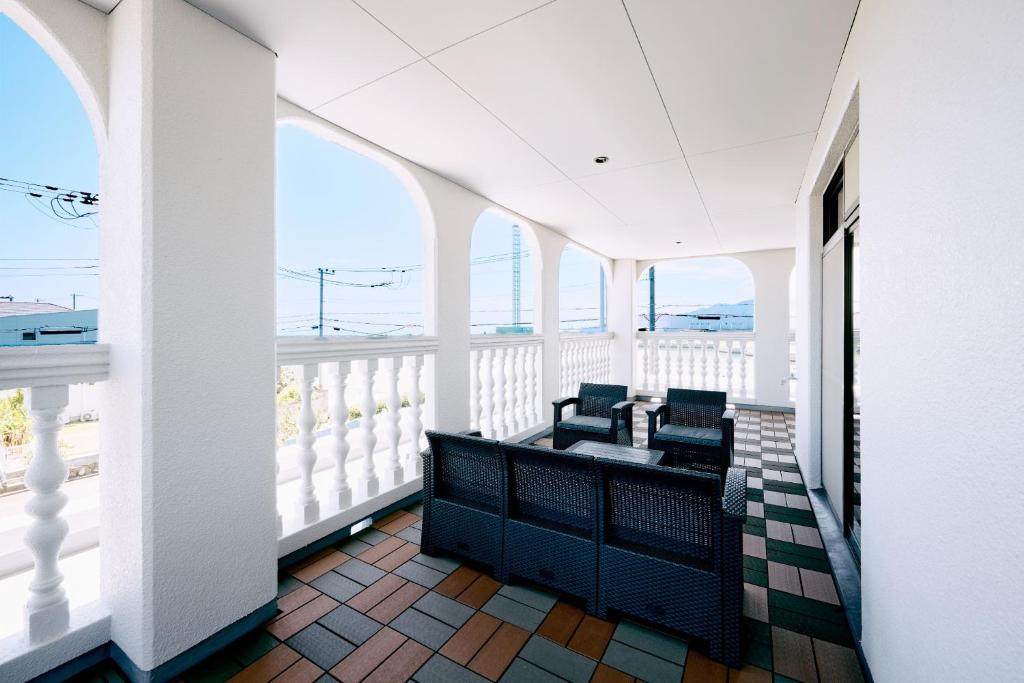 a balcony with chairs and views of the ocean at Nostalgia Oiso Awaji - Vacation STAY 66330v in Kusumoto