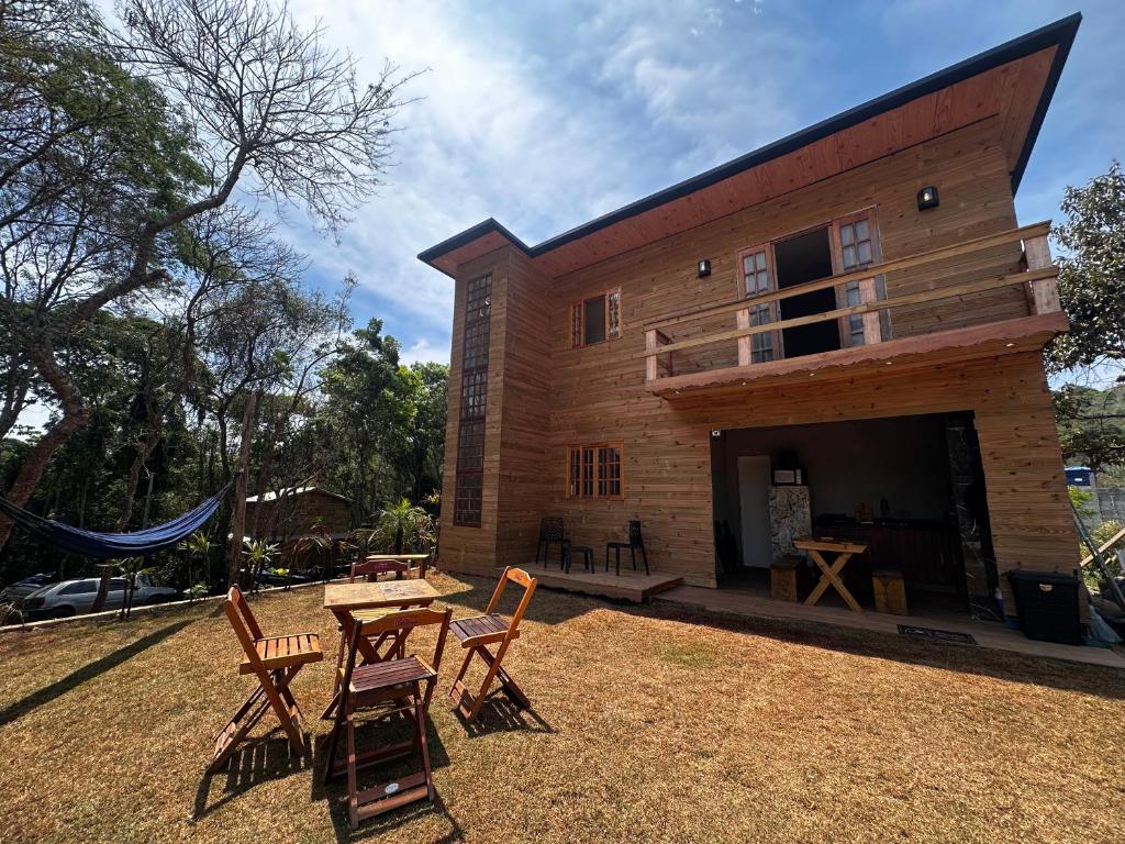 a house with a table and chairs in the yard at Cabana Americana in Mairiporã