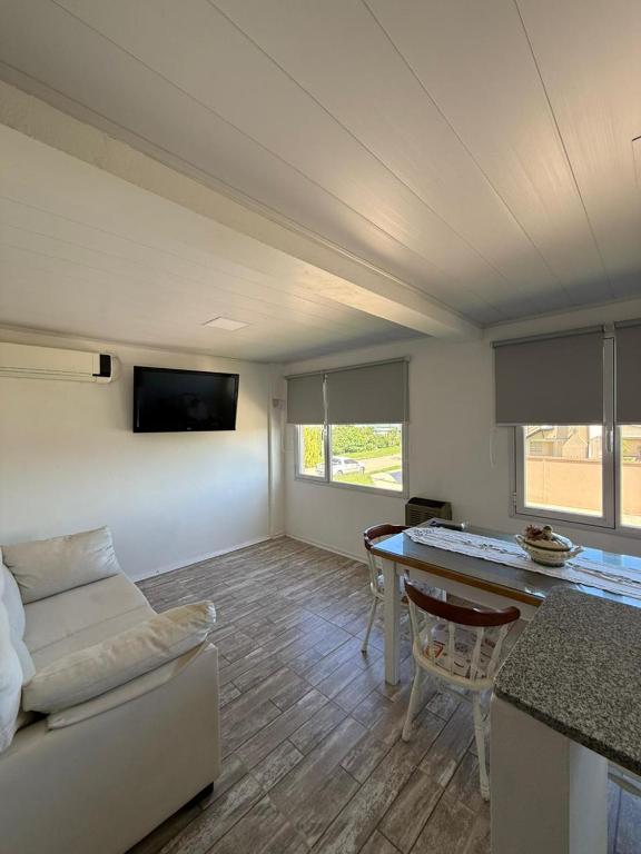 a living room with a couch and a table at Luz del cielo premiun in Necochea