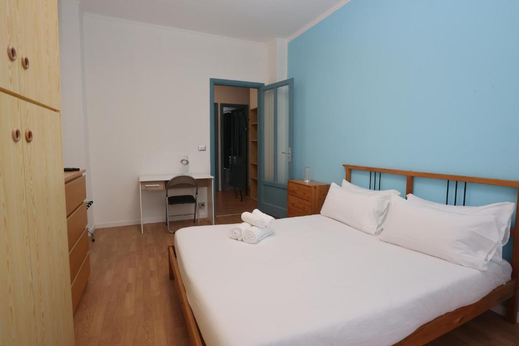 Ένα ή περισσότερα κρεβάτια σε δωμάτιο στο Home & Holiday Bizzozzero