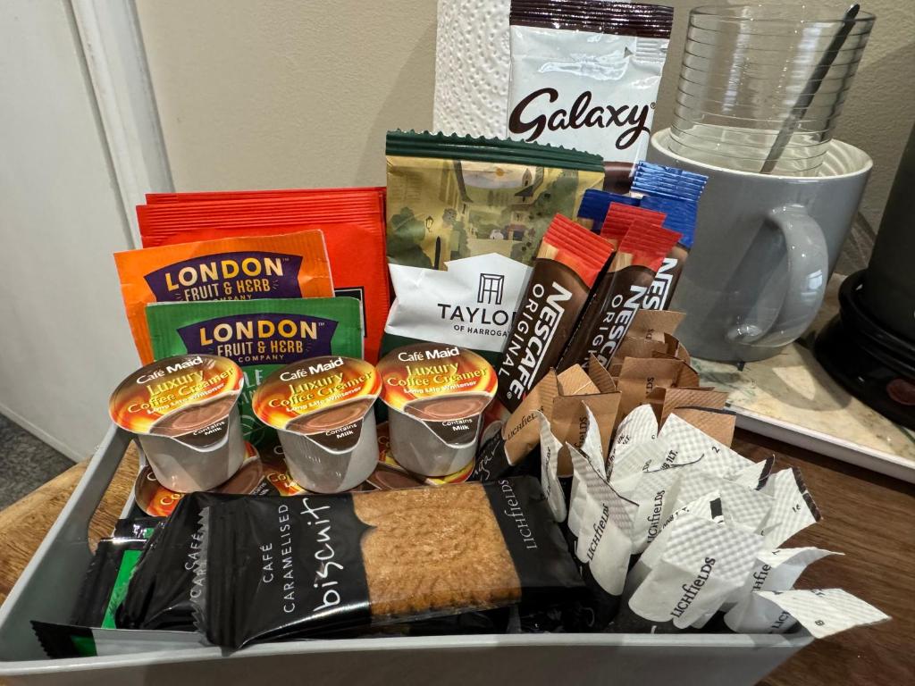 a basket filled with food and other snacks on a table at Bed for the night, Close to Beach, Shops , Train in St. Leonards