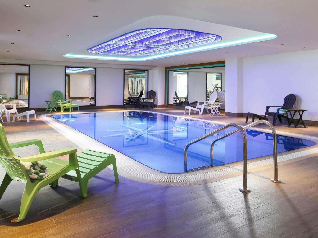 a large swimming pool in a hotel room at Ibis Styles Dubai Jumeira in Dubai