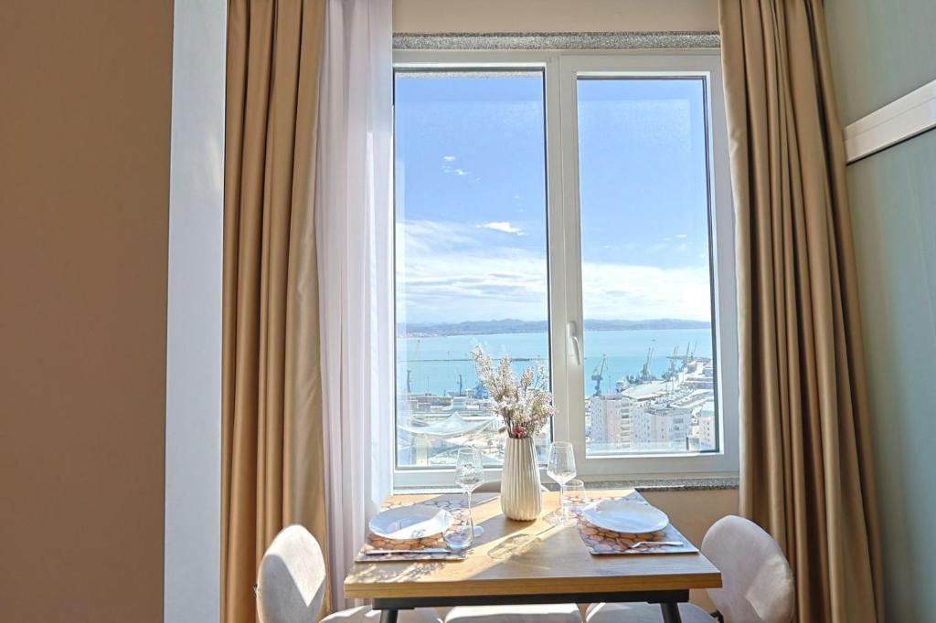 a dining room table with a view of the ocean at Lux Holidays 221 in Durrës