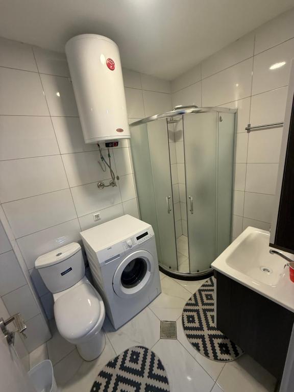 a bathroom with a toilet and a shower and a sink at Banes me qira in Kosovo Polje