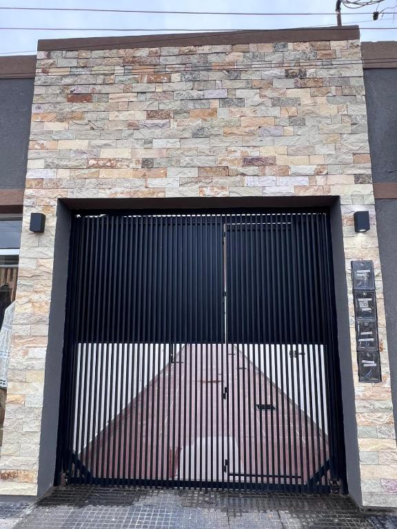 a large metal garage door on a brick building at Alojamiento Madariaga 224 in Goya