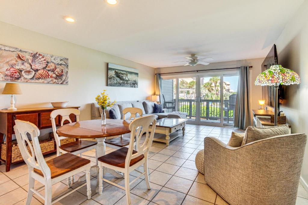 a living room with a table and chairs at Poolside Fun & Ocean Strolls: Harbor Island Haven! in Fripp Island