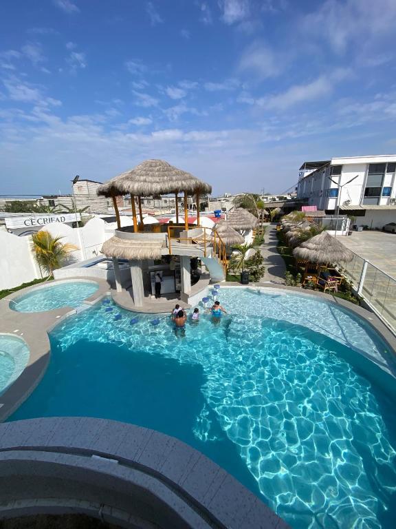 a swimming pool with a gazebo in a resort at Hotel Presidente Beach Salinas in Salinas